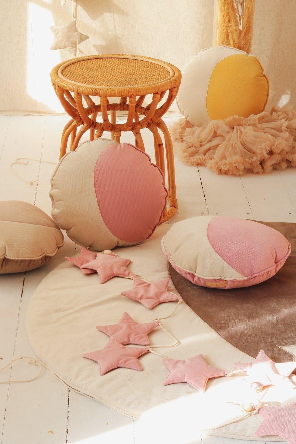 bold close-up of a soft pink velvet star garland with wooden beads, artisan-made for a magical nursery