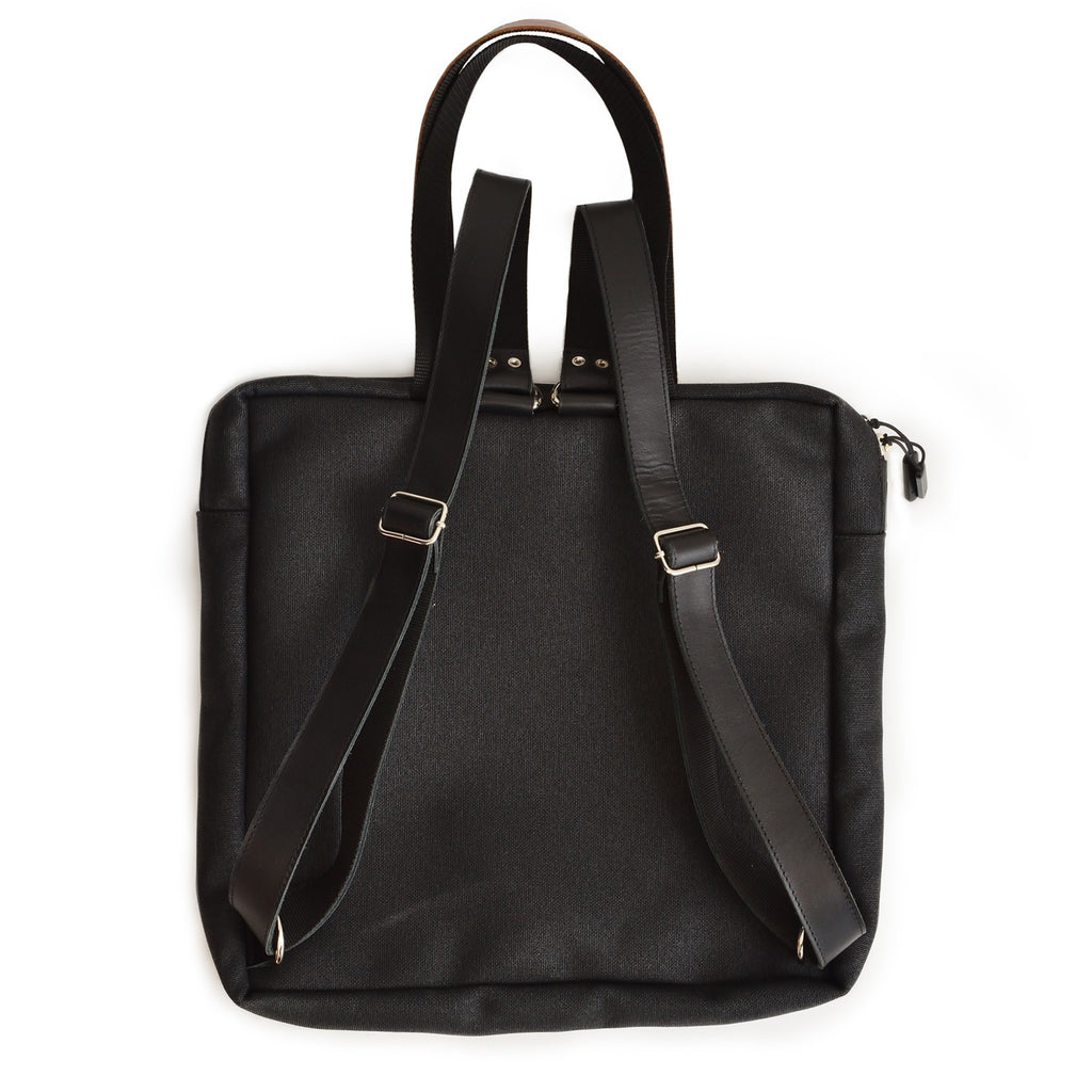 playful beige stockholm backpack with leather details, open front pocket showing anti-theft ykk zip