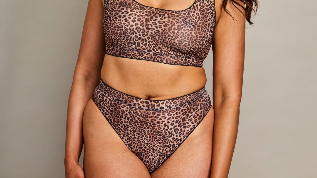 elegant tan-through long sleeve bikini set in soft morning light on a serene beach