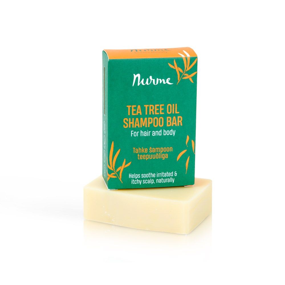 a close-up of a soft green tea tree shampoo bar resting on a natural linen cloth