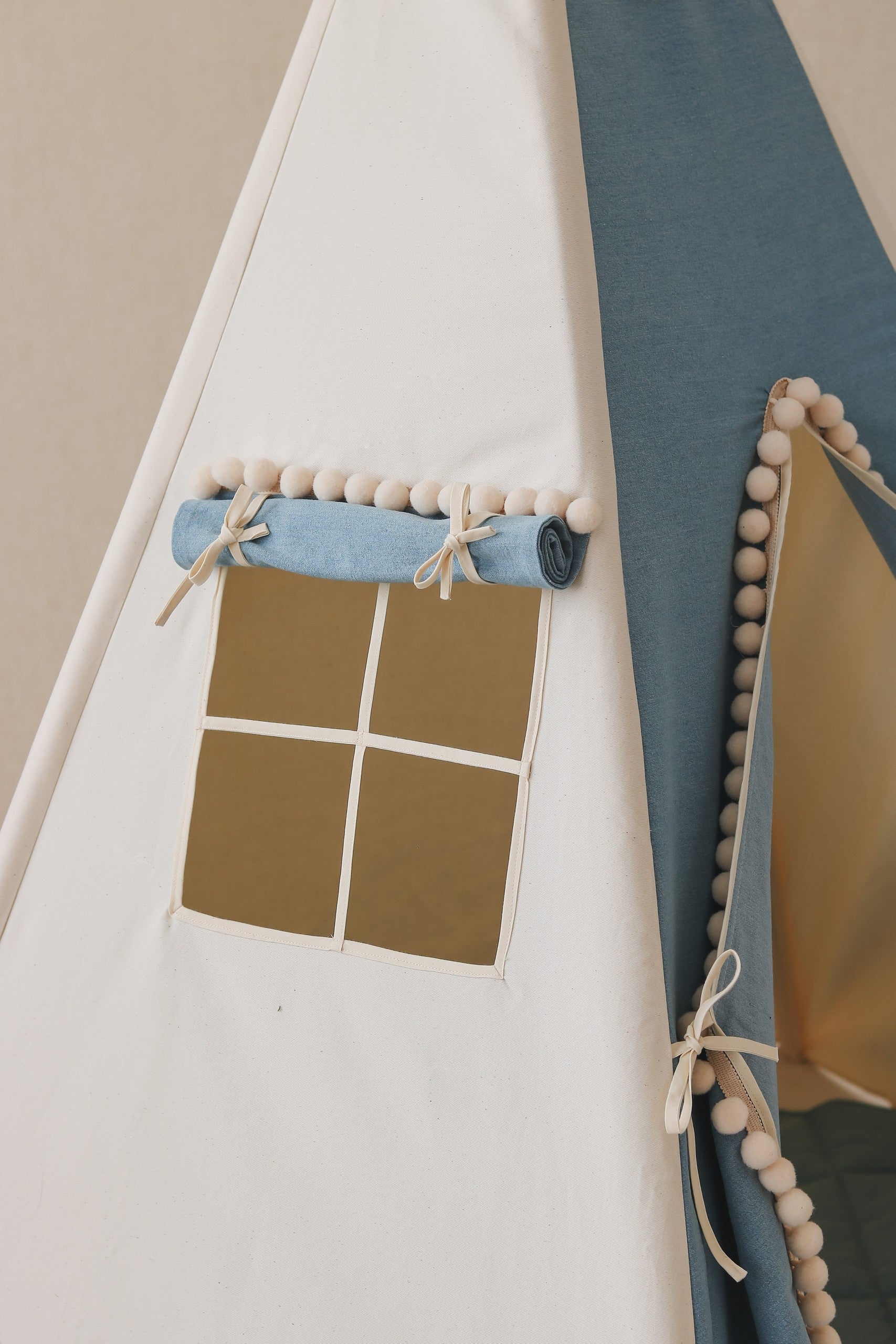 playful denim teepee tent with bouncy pompoms, perfect for kids' imaginative adventures and cozy hideouts