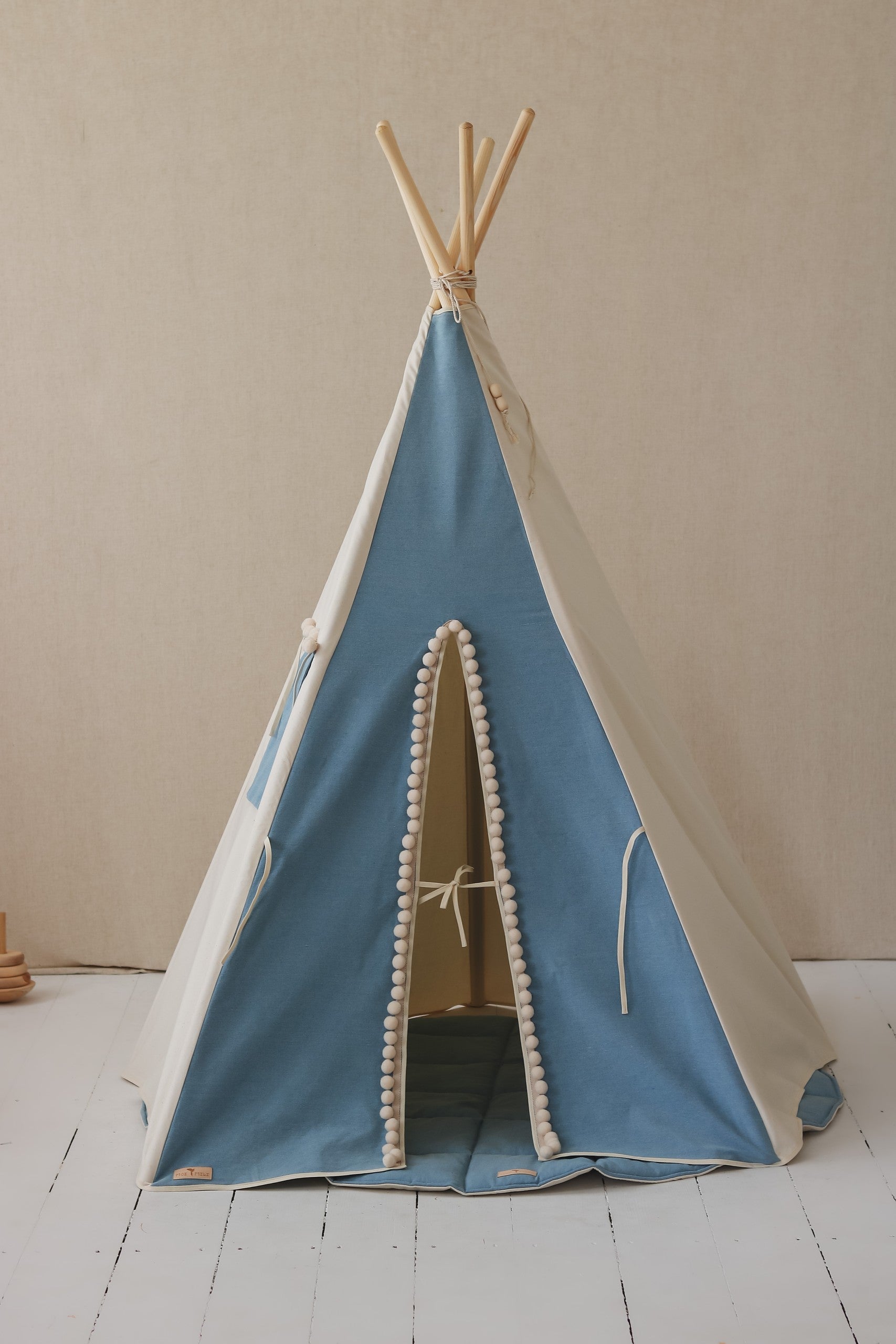 elegant denim teepee tent with playful pompoms, perfect for imaginative kids' adventures and cozy retreats