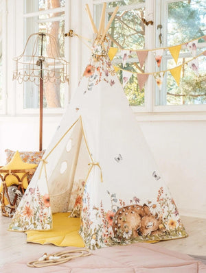 bold wildflowers teepee tent with pine poles and playful deer print in a sunlit room