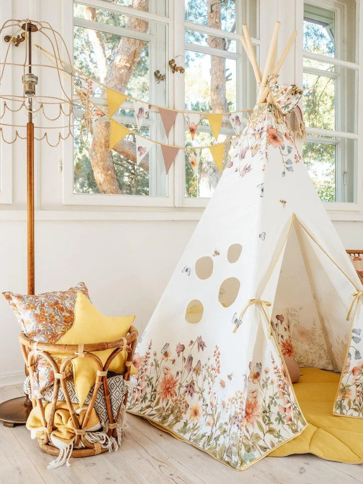 close-up detail of wildflowers teepee tent assembly showing sturdy pine pole connection