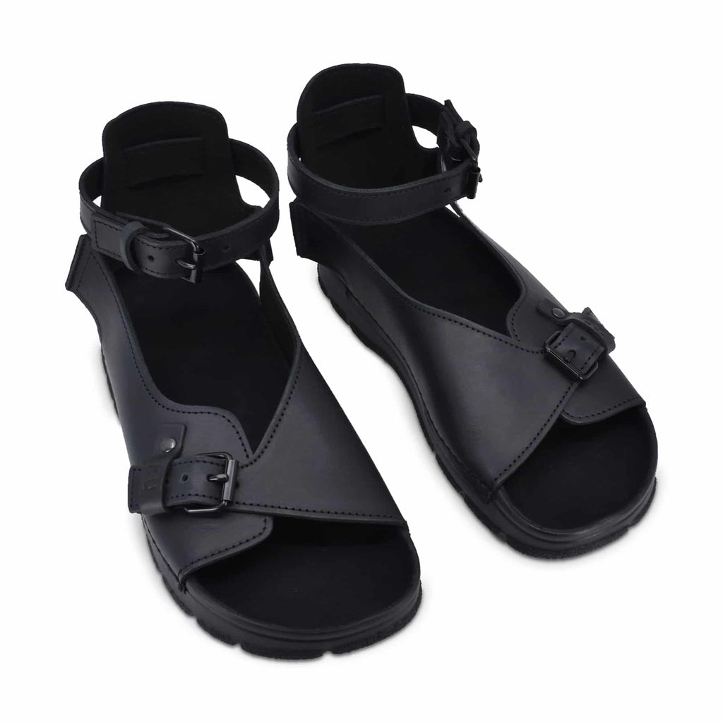 black toku athens sandals with adjustable ankle strap, showcasing durable polyurethane outsole on a neutral background