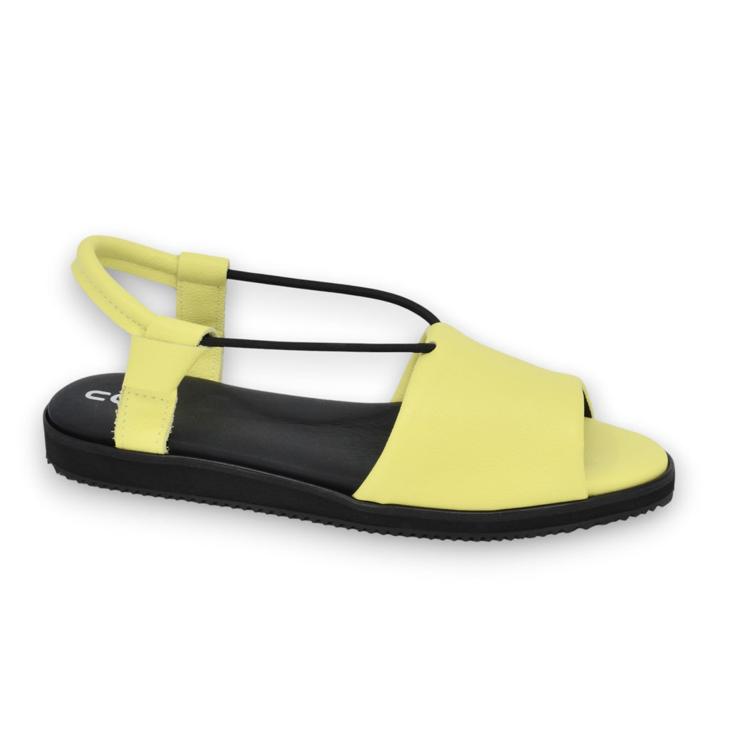 playful lime yellow toku berlin sandals with leather upper and soft lycra lining, shot in golden sunlight