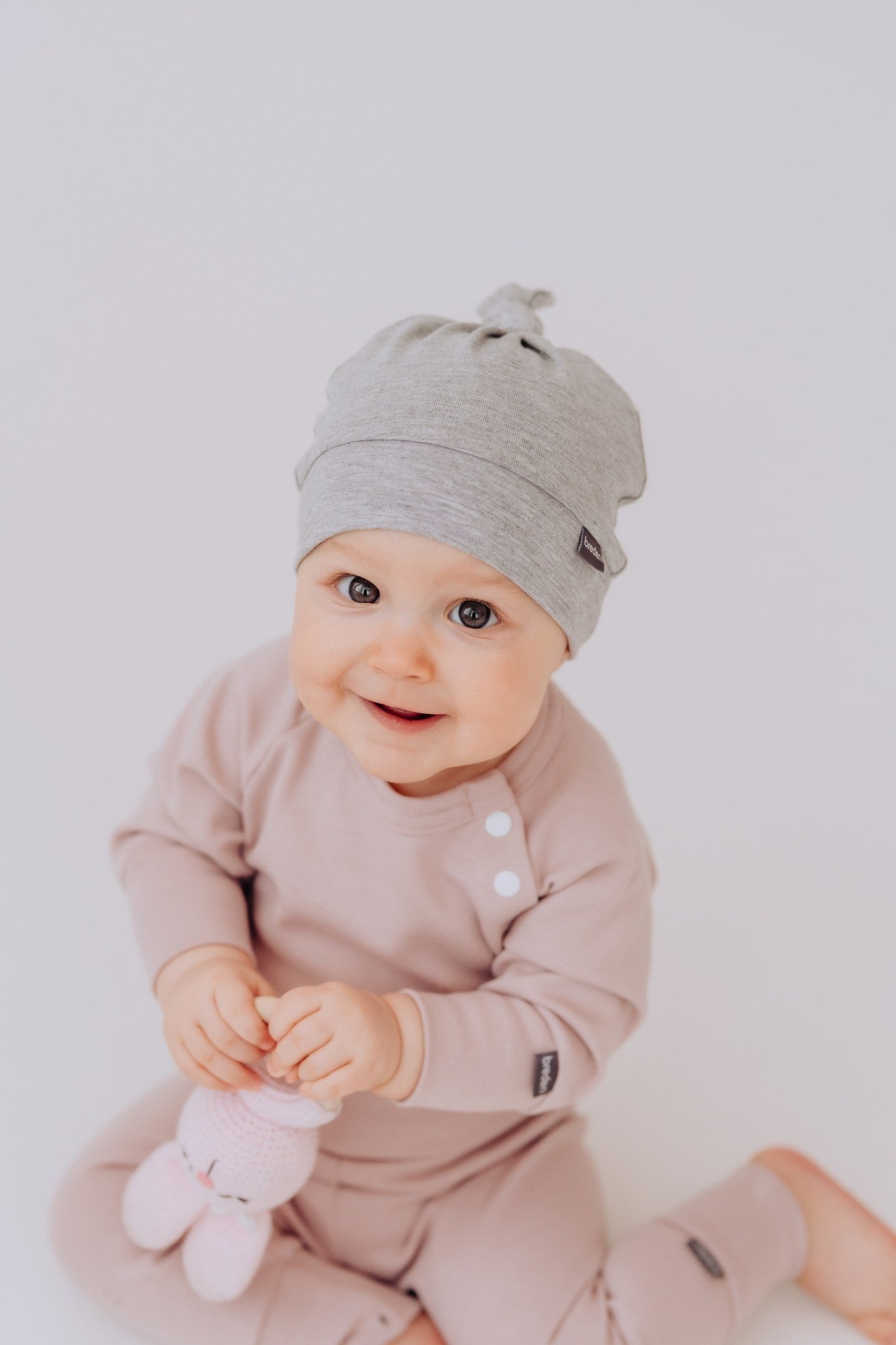 elegant bamboo viscose baby hat with a refined adjustable knot, shown in soft natural light