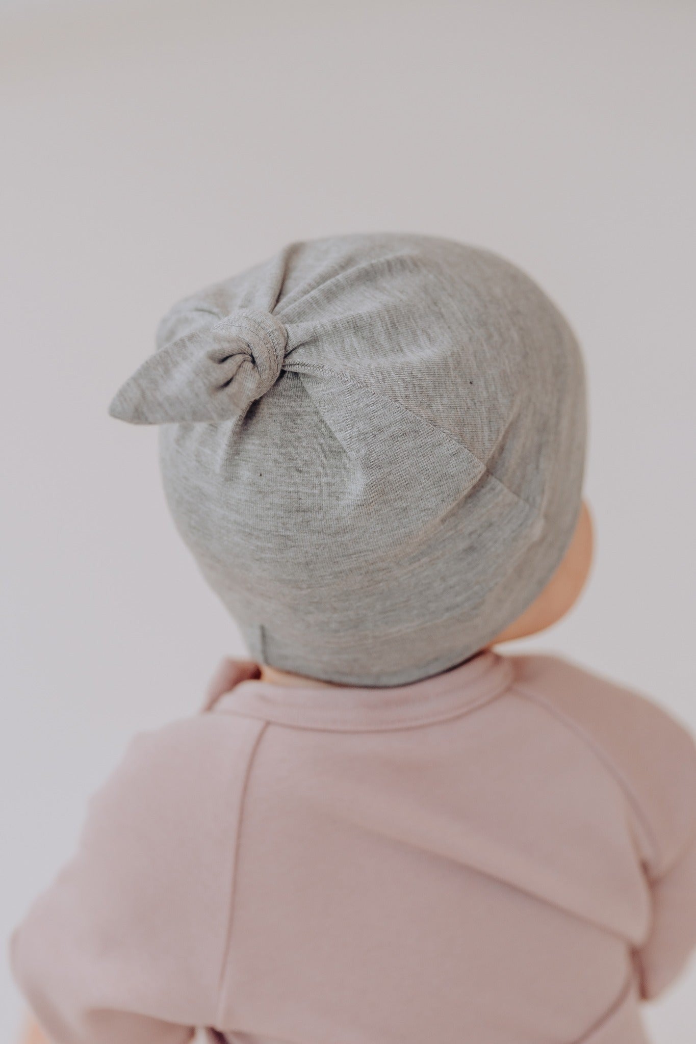 close-up of the adjustable knot on a soft bamboo baby sun hat for a perfect fit