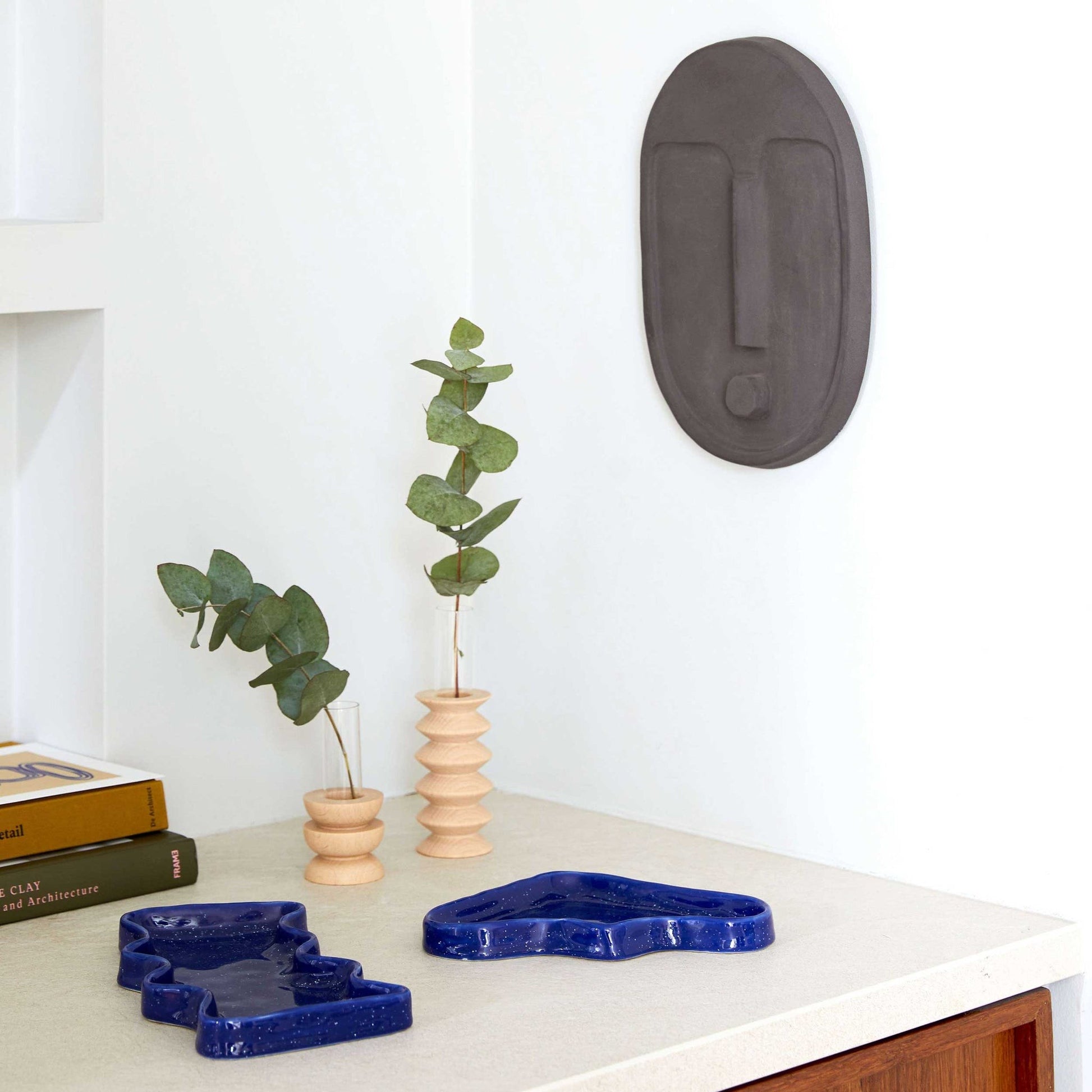 softly lit medium totem vase on a cozy side table with warm wood grain detail