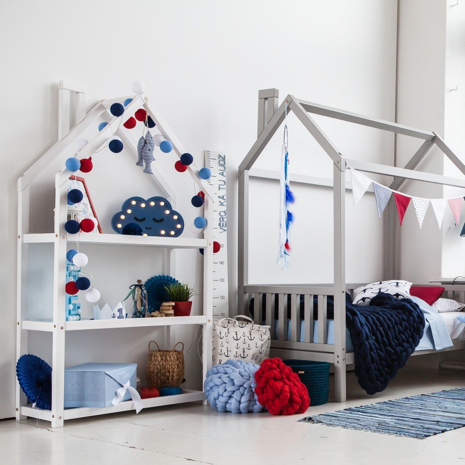 playful white house-shaped kids shelf with toys and books in a sunny nursery, montessori-style