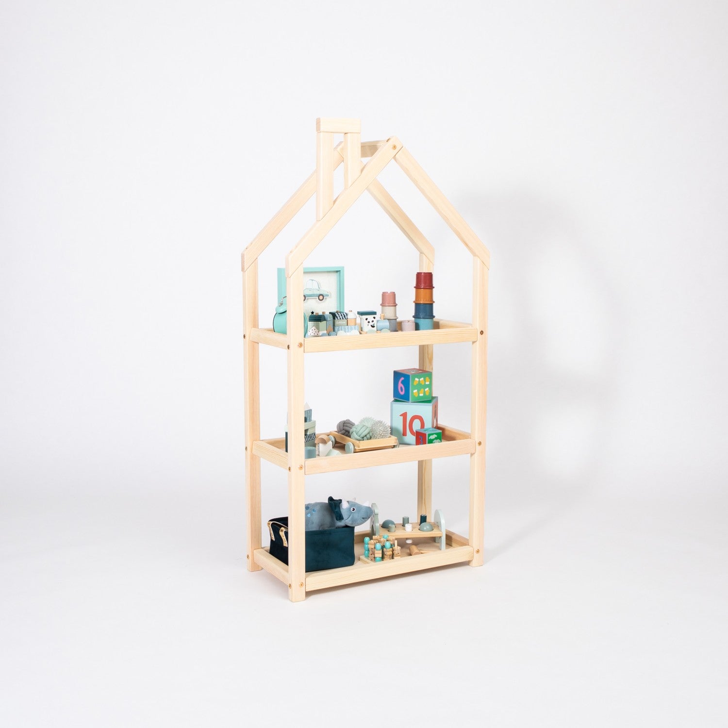 adorable white house-shaped kids shelf with toys displayed in a cozy nursery corner