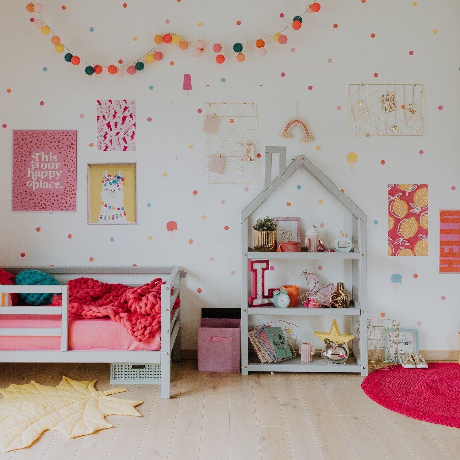 adorable house-shaped kids shelf in soft grey, filled with colorful books and toys, bathed in warm nursery light