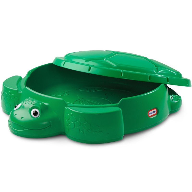 adorable green turtle sandbox with shell lid open, soft sunlight highlighting the smooth plastic seats and playful sand-filled interior