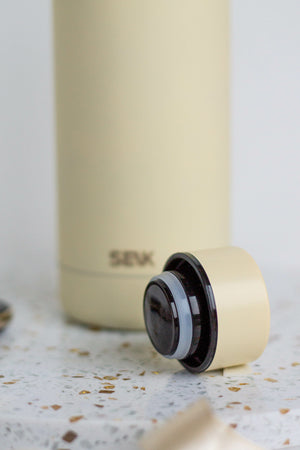 bold seik unista thermos in dramatic studio lighting showcasing its sleek 500ml stainless steel form
