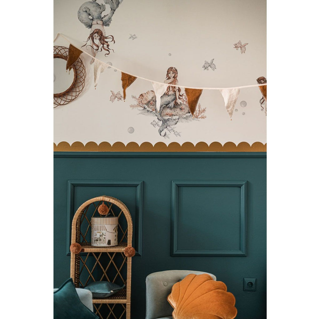 soft golden circle wall decals arranged in a gentle arc on a nursery wall, casting a warm glow
