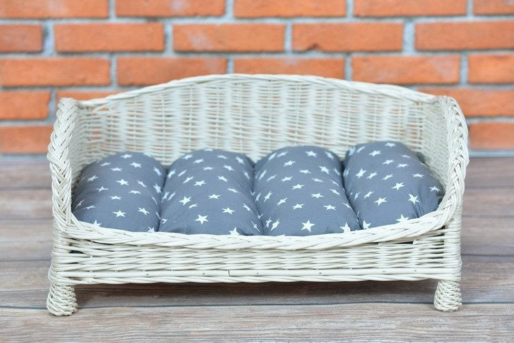 bold showcase of the alfie wicker pet bed with plush cushion in a modern living room