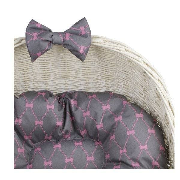 elegant whitewashed wicker pet house with plush cushion and decorative bow, a refined sanctuary