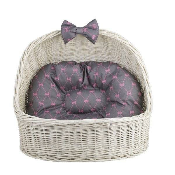 bold front view of a stylish whitewashed wicker pet house for a cat or small dog