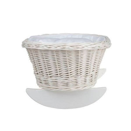 elegant wicker doll cradle with white bedding in soft morning light