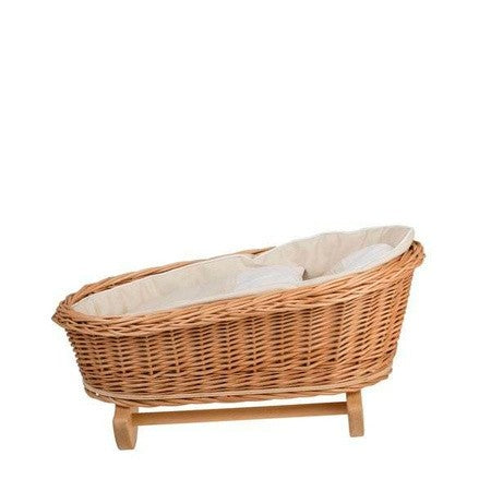 a playful wicker doll cradle with soft white bedding, ready for a teddy bear to nap