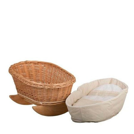 wicker rocking cradle mimi with soft white bedding in a cozy nursery corner