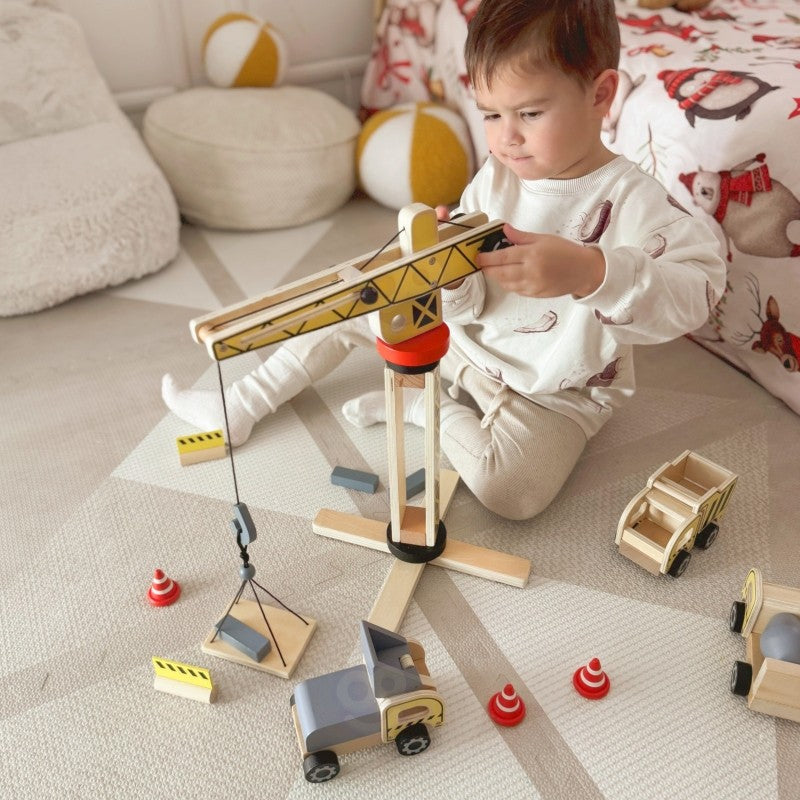 close-up of the artisan-made wooden crane lifting a block on a sustainable playset