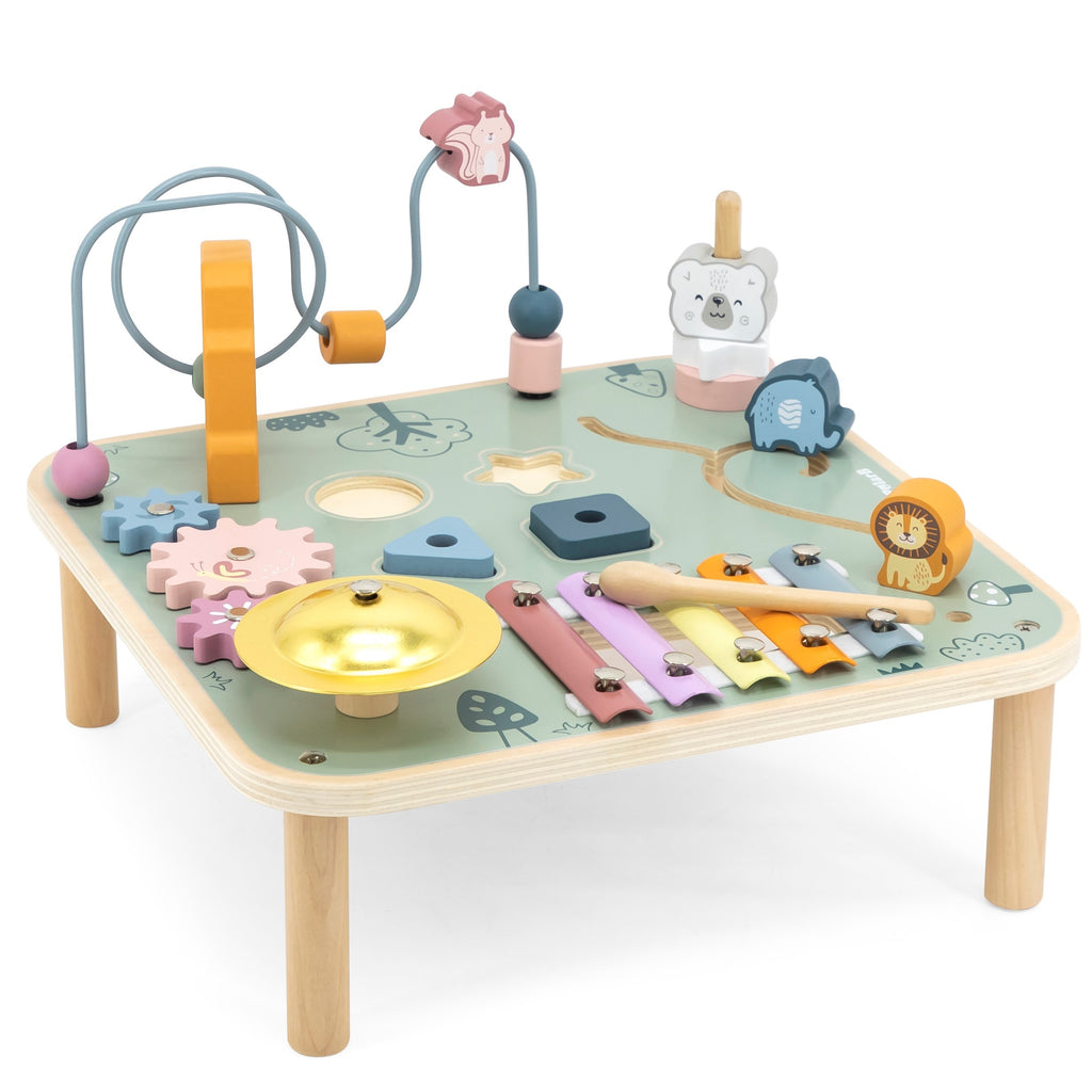 close-up of a toddler’s hands playing with colorful wooden gears and xylophone on the sensory table