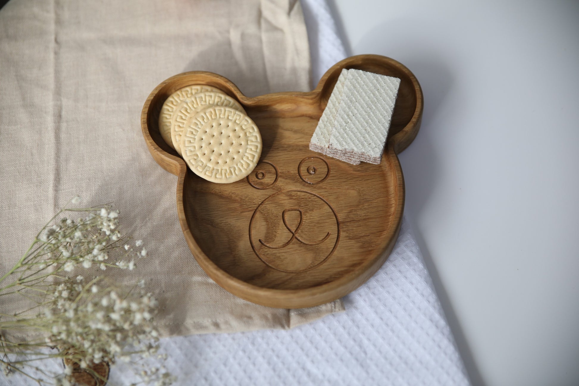 bold close-up of a handcrafted wooden bear plate for kids on a rustic table