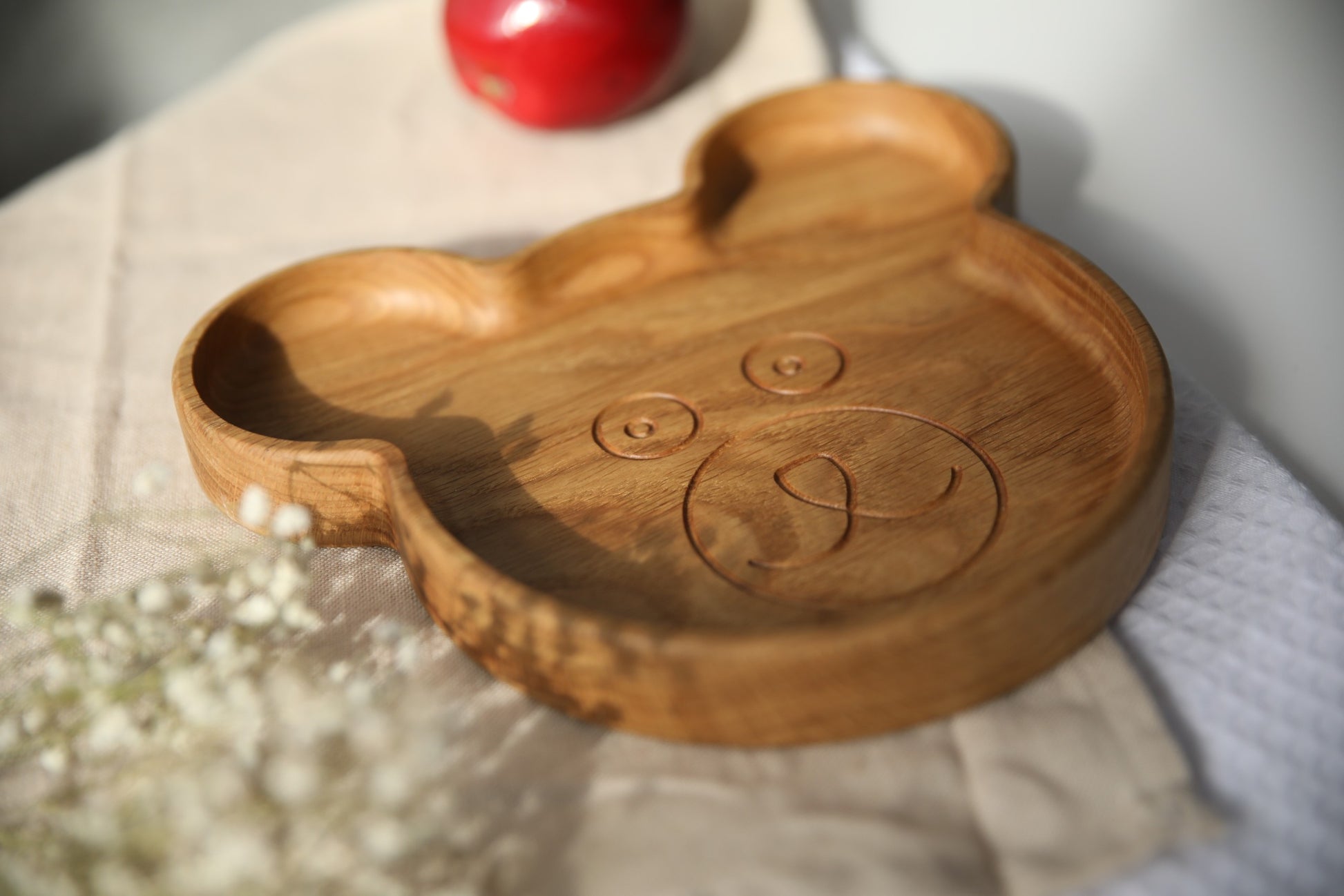 handmade ukrainian wooden bear plate for kids on a rustic table setting