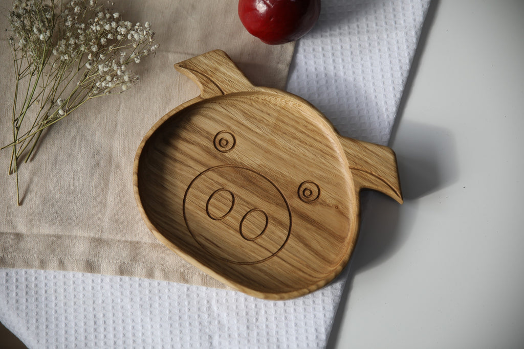 soft-lit handmade wooden kids plate with smooth polished surface and warm natural wood grain