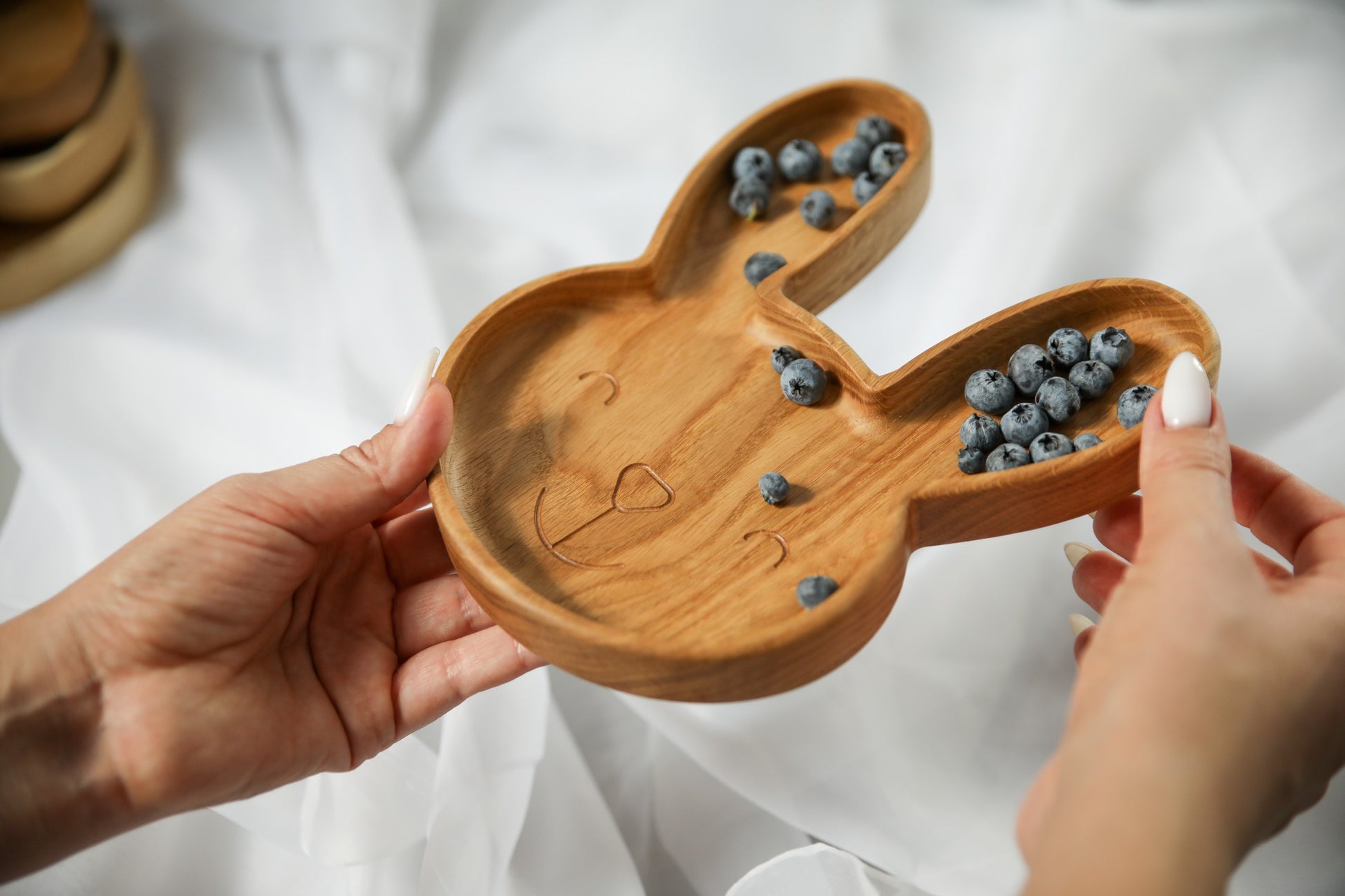 soft-lit wooden bunny plate for kids, hand-polished oak with smooth curves, resting on a cozy kitchen table