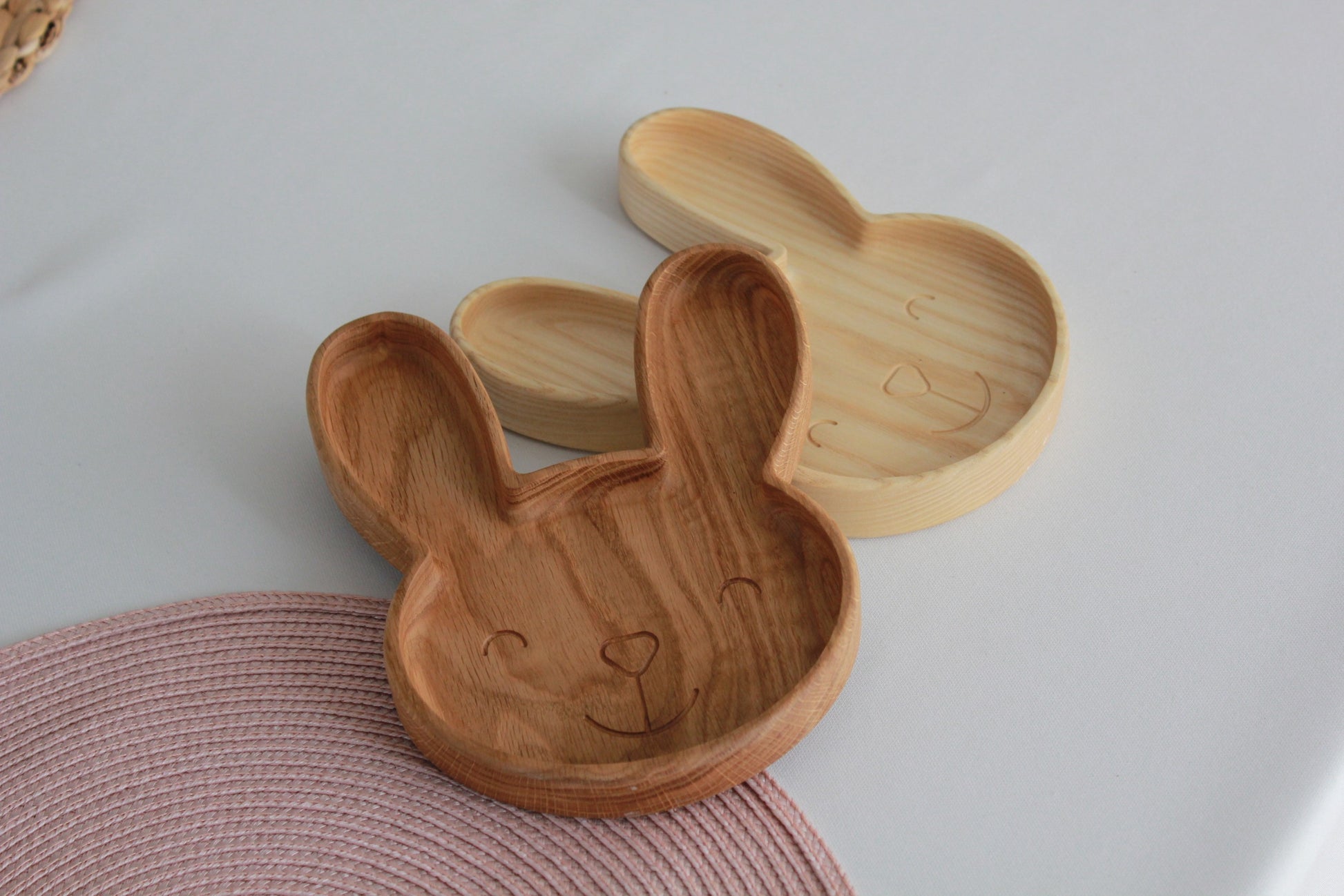 handmade wooden bunny plate for kids on a rustic table, showcasing its smooth oak surface and playful design