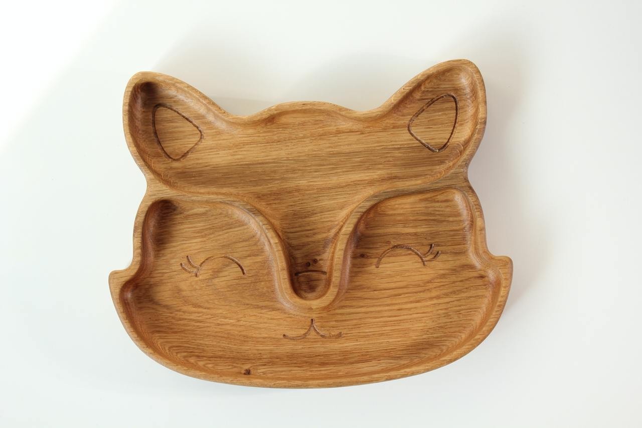 handmade wooden fox plate for kids on a rustic table, showcasing its smooth two-sector design and natural wood grain
