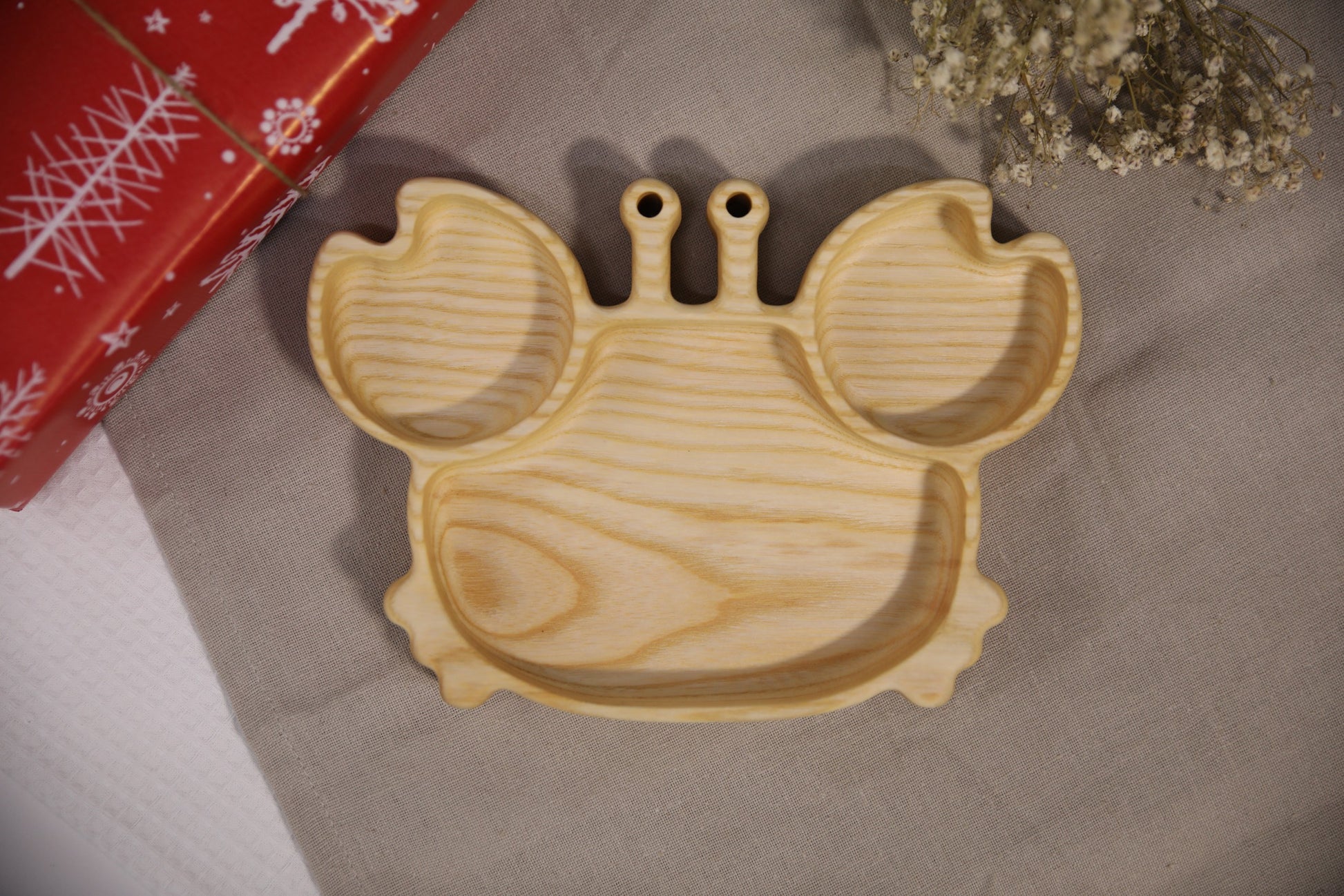 playful crab-shaped wooden plate for kids on a sunlit table, hand-polished oak with smooth edges