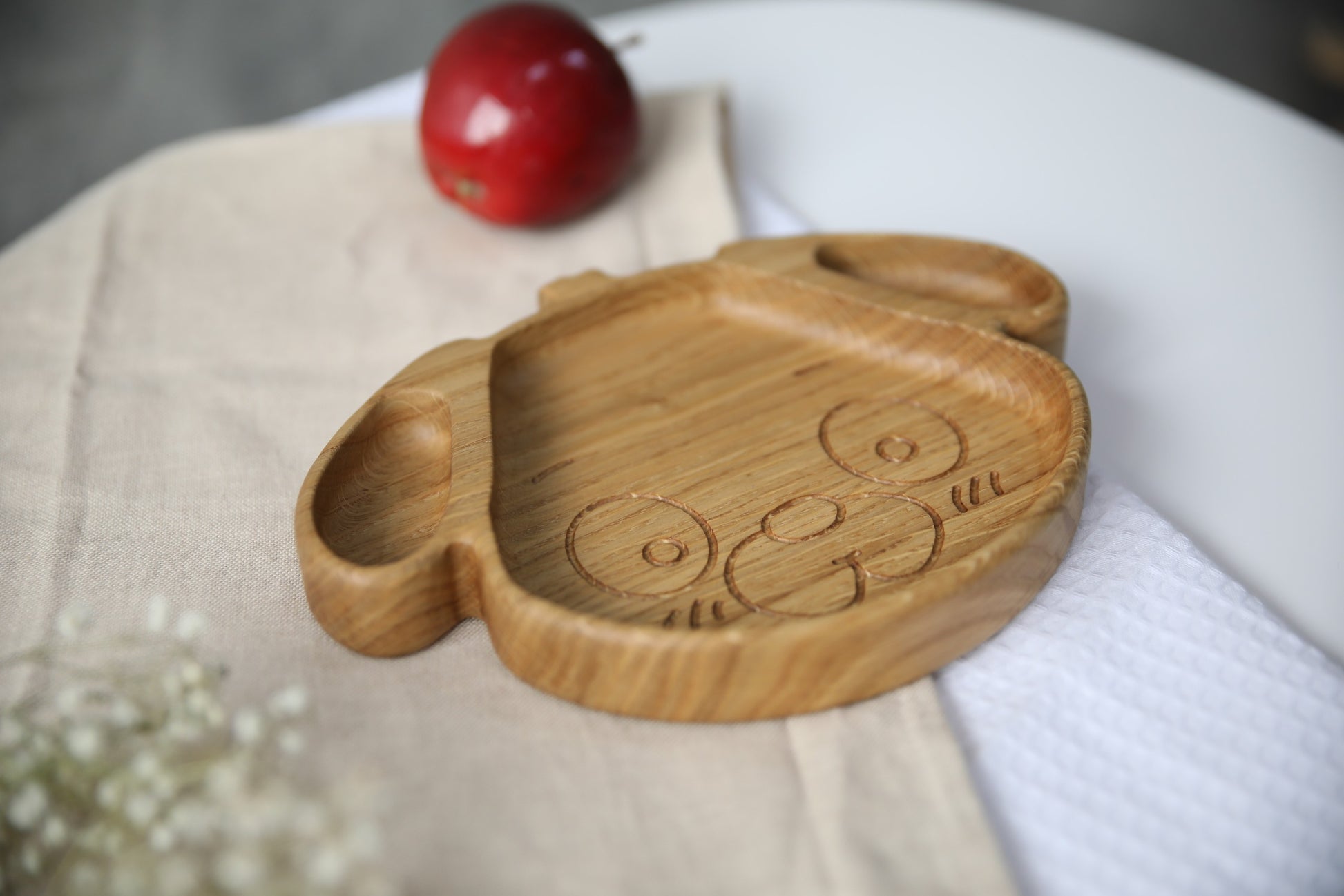 soft-lit handmade wooden dog plate for kids, smooth oak surface with warm natural grain, cozy mealtime vibe