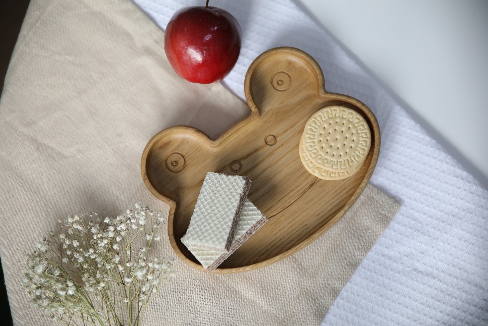 functional wooden frog plate for kids on a neutral tabletop, showcasing its smooth hand-polished oak surface and practical size