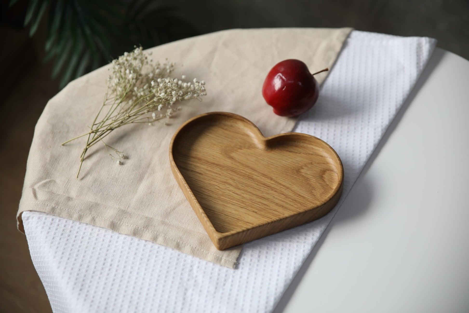 playful heart-shaped wooden kids plate with a personalized name engraving on natural oak