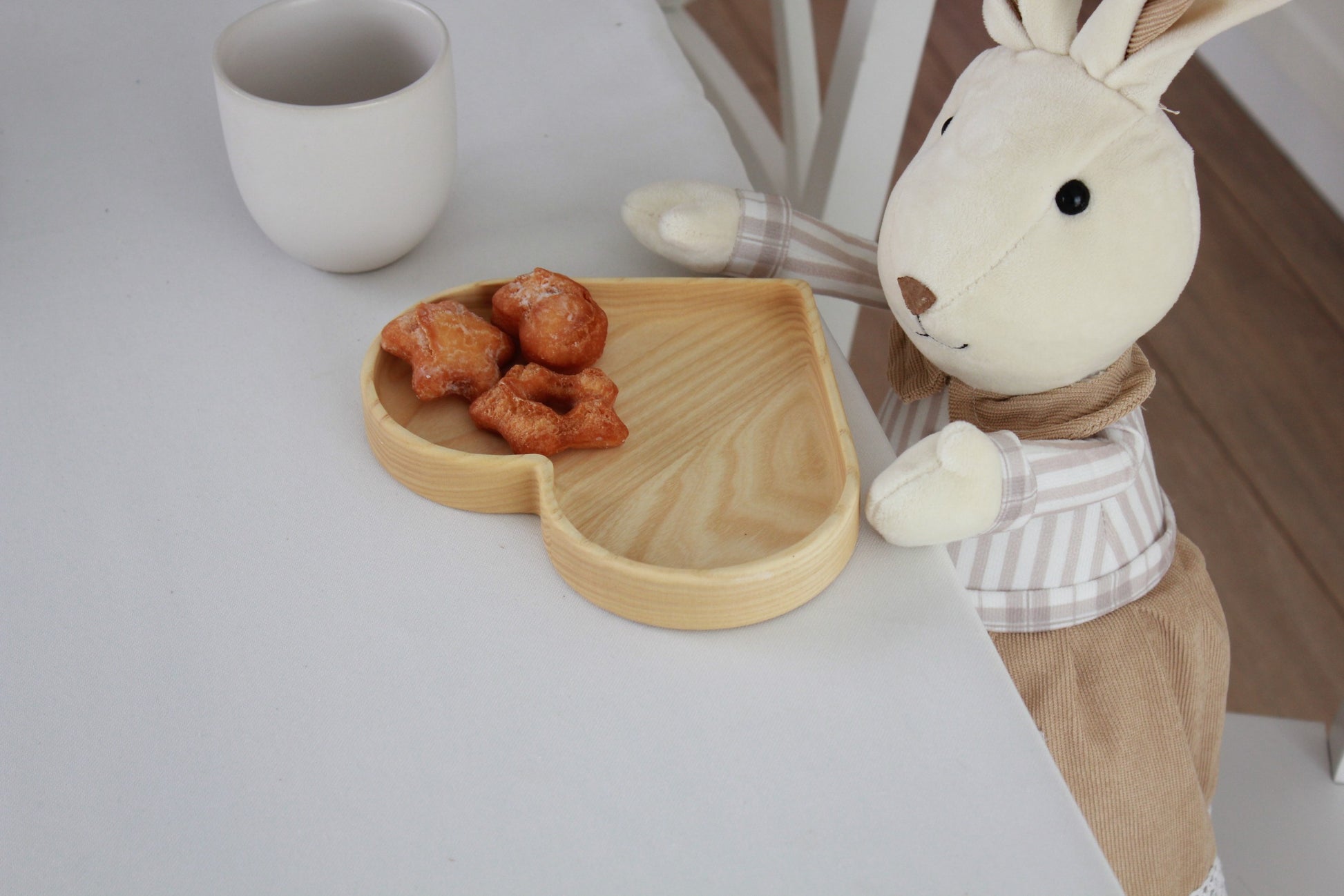 softly lit heart-shaped oak plate for kids on a cozy table, a safe and comforting mealtime gift