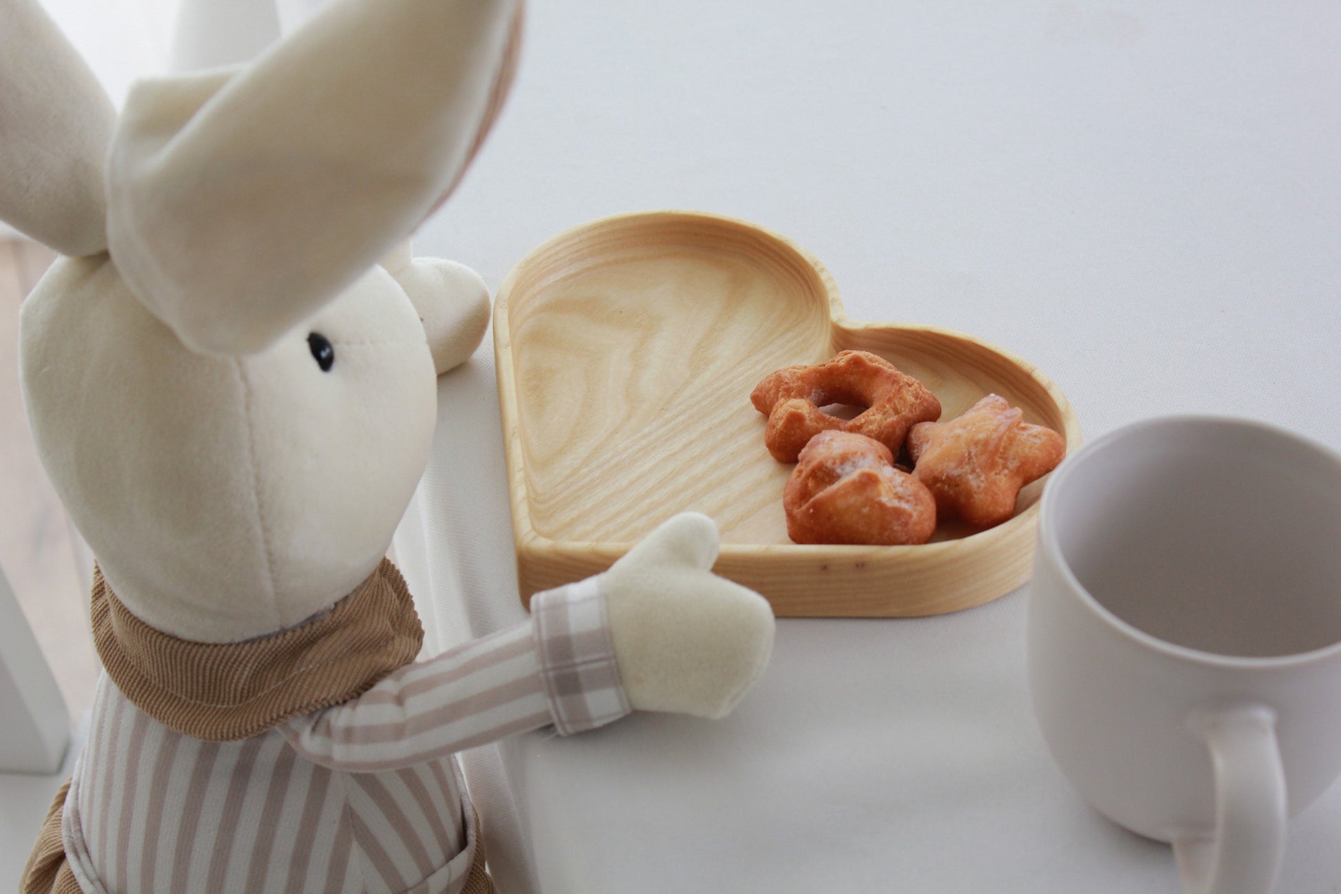 elegant close-up of a handcrafted heart-shaped oak plate for kids on a minimalist table