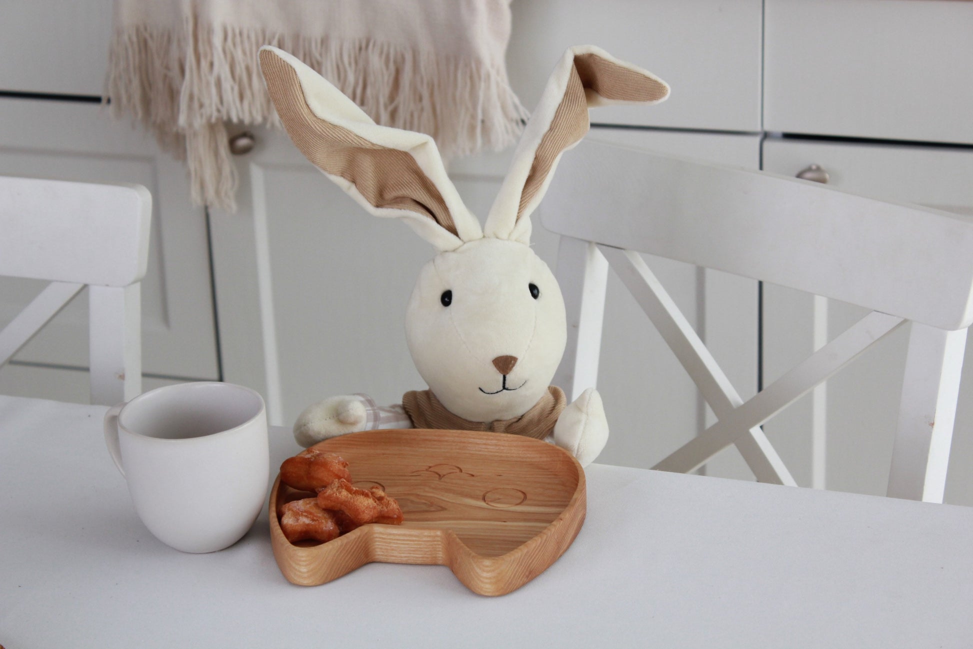 soft-lit wooden kids plate with a kitty design, hand-polished oak surface glowing warmly in natural light