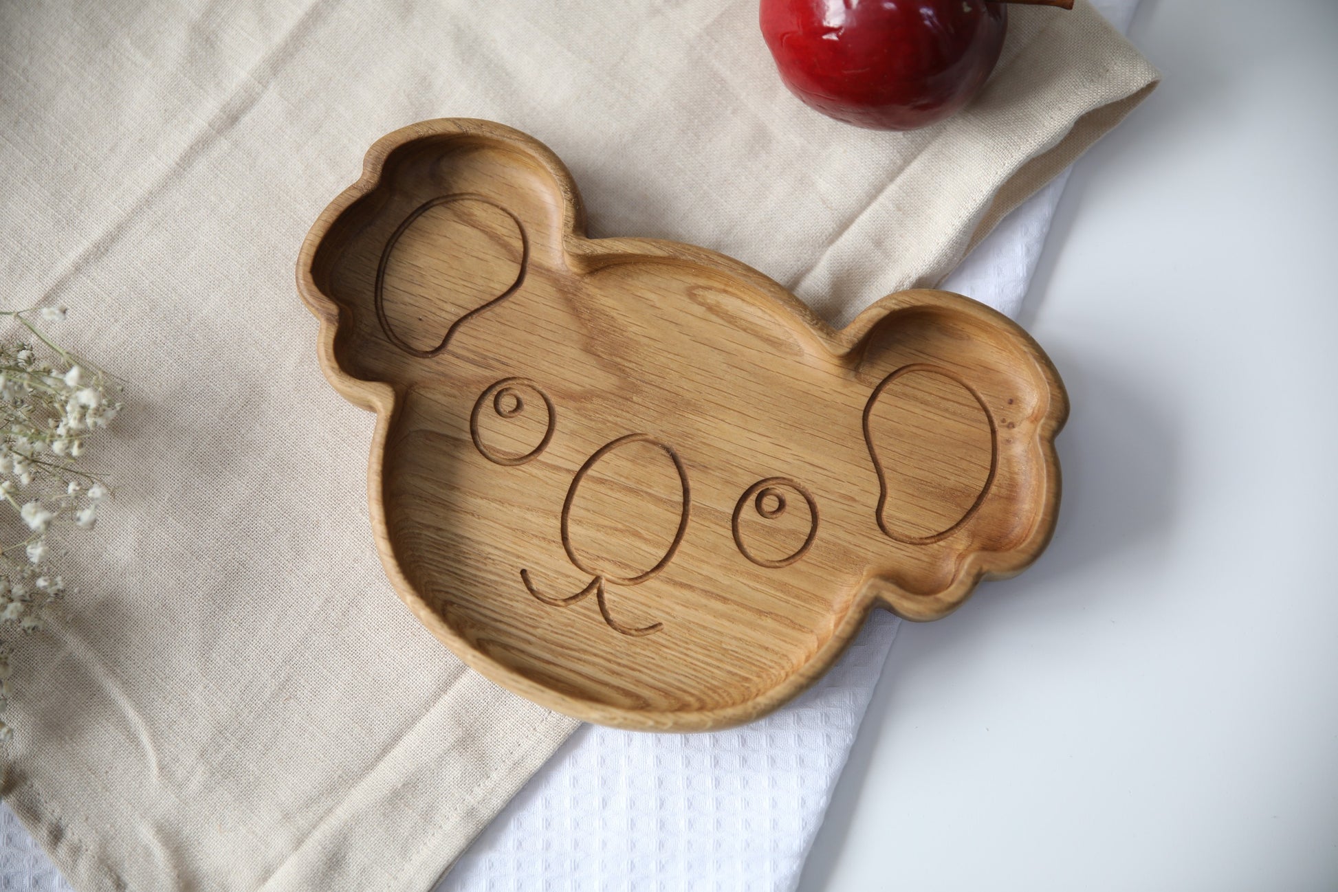 adorable koala wooden plate for kids on a rustic table, showcasing smooth hand-polished oak and playful engraving options