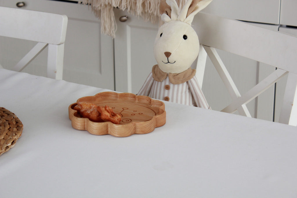 playful lion wooden plate for kids on a sunlit table, handmade from natural oak with smooth polished surface
