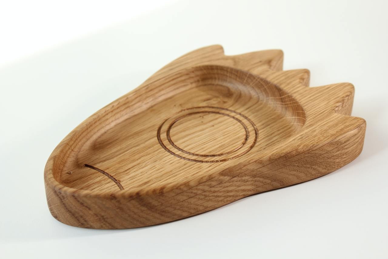 handmade wooden rocket plate for kids on a soft linen tablecloth, showcasing smooth oak finish and gentle craftsmanship