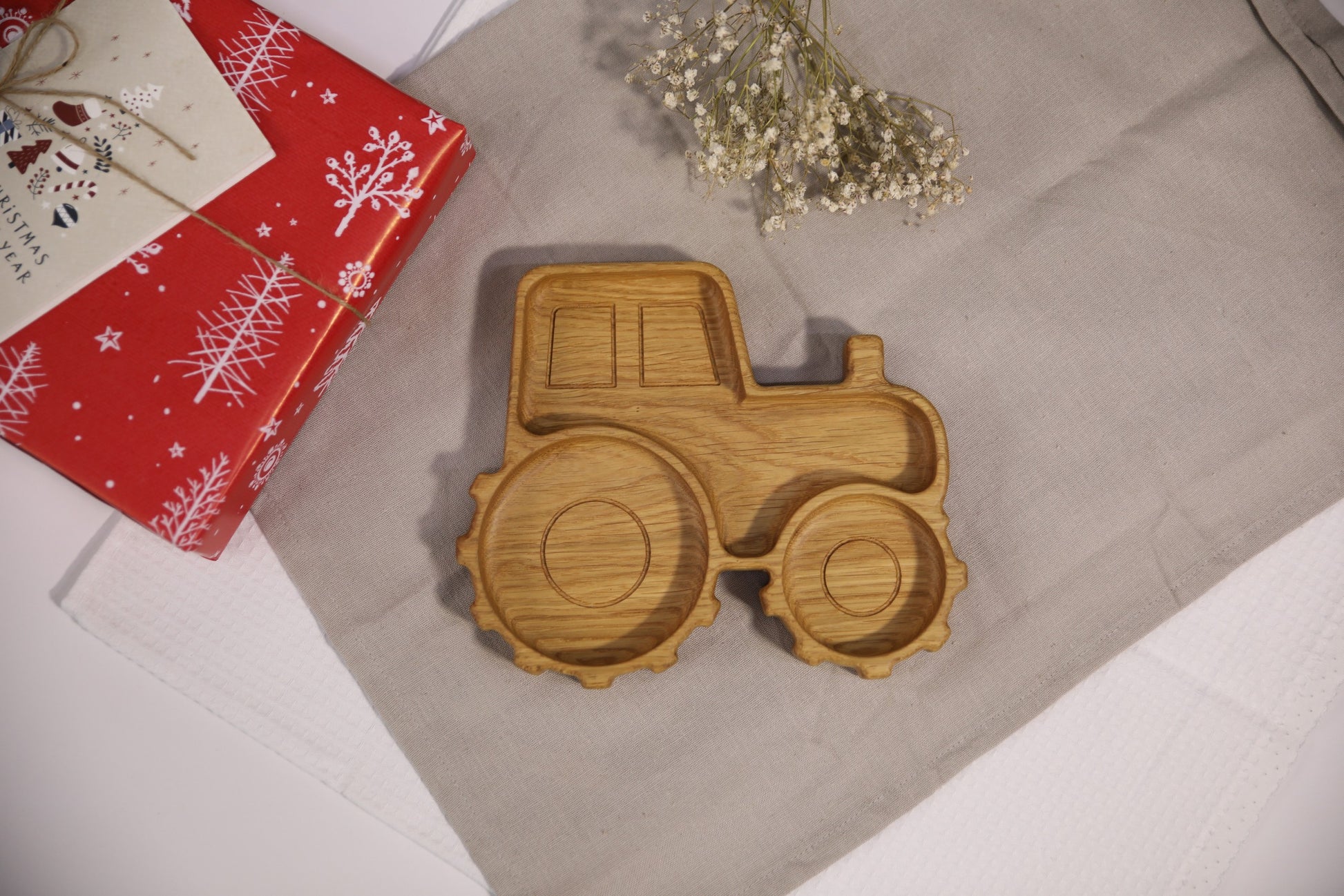 elegant handcrafted oak kids plate with a detailed tractor design, showcasing its refined grain and smooth finish