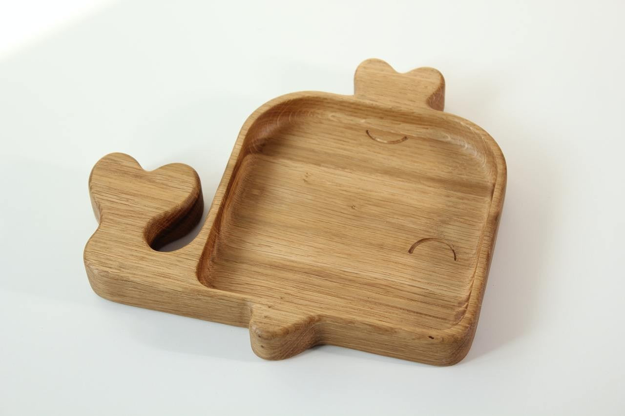 handmade wooden whale plate for kids on a rustic table, showcasing smooth oak grain and playful whale design