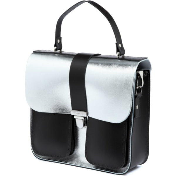 a soft-focus shot of the silver leather bag with its warm chocolate base glowing in gentle light