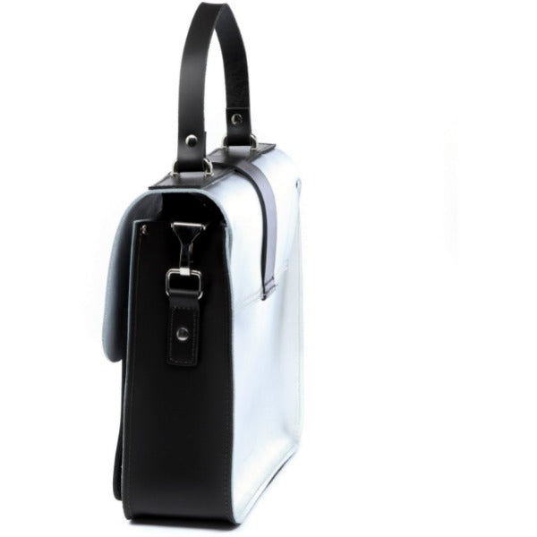 silver leather top handle bag with front pockets and signature lock closure shown from a practical angle